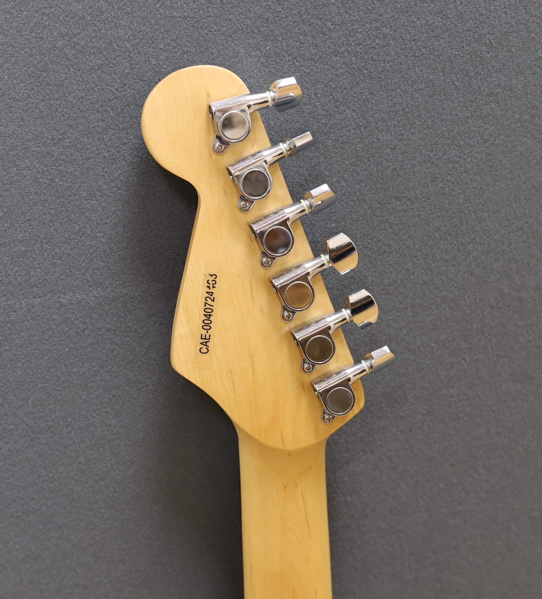 A Squier Strat by Fender Sunburst electric guitar made in China with rosewood neck, together with a small Squire SP-10 amp